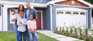 Happy Black Family Standing Outside Their House