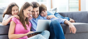 Family Using Laptop At Home