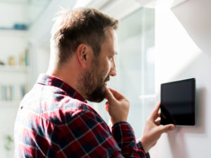 Man Using Smart Home Device