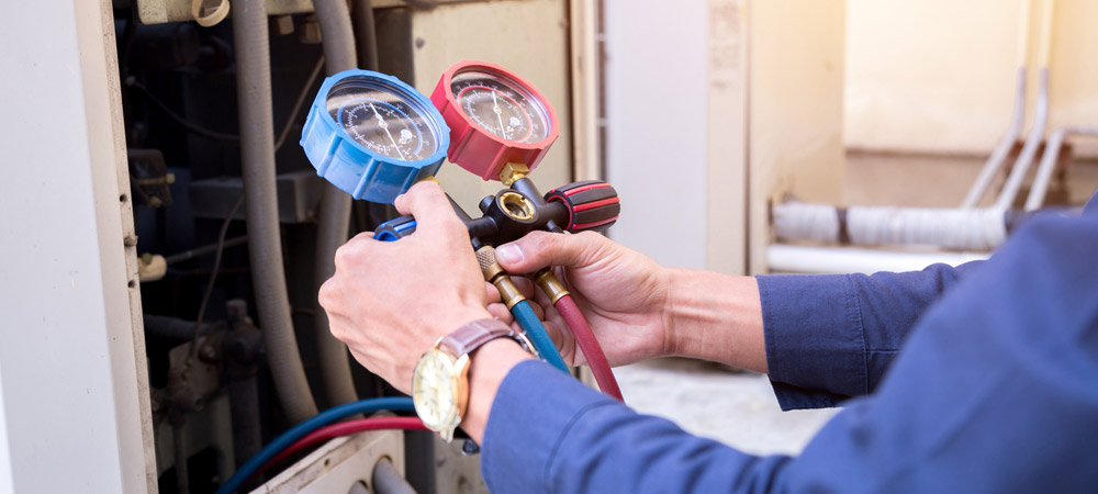 ac repair technician with gauges