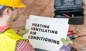 Workman Holding Paper That Says 22heating Ventilating Air Conditioning22