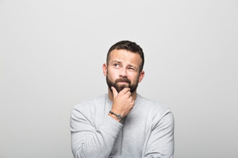 man thinking with his hand on his chin